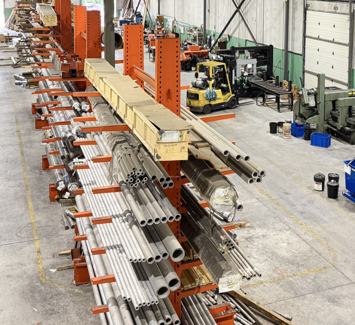 A warehouse containing stainless steel pipes.